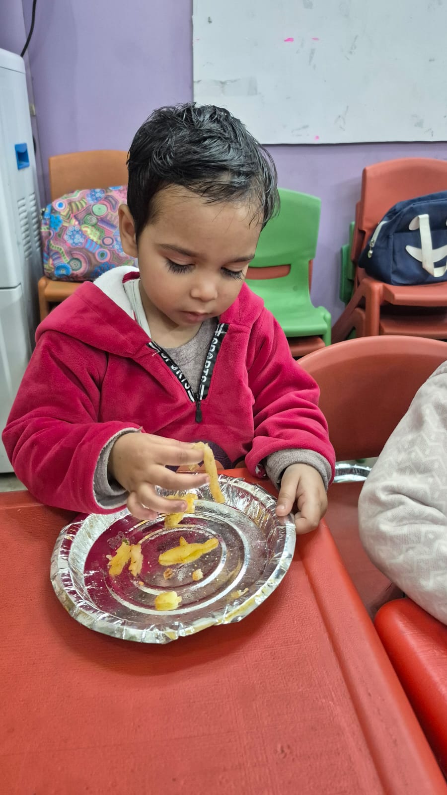 Teacher handing out foil-wrapped food items